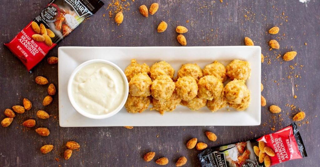 Plated buffalo chicken meatballs with Legendary Foods packages